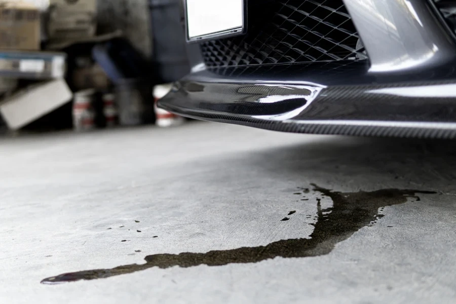 What causes oil stains on driveways?
